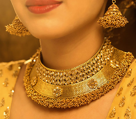 A woman wearing gold jewelry